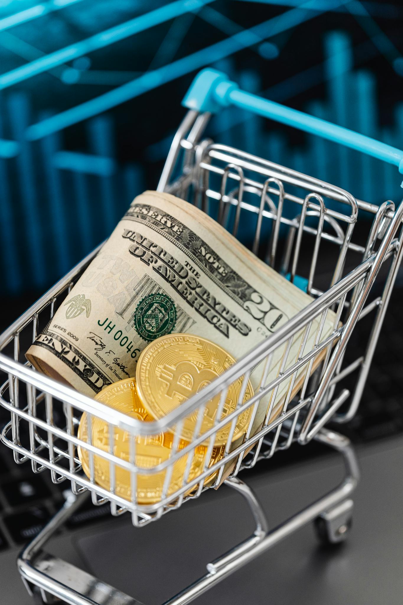Shopping cart filled with bitcoins and US dollars, symbolizing digital investment.